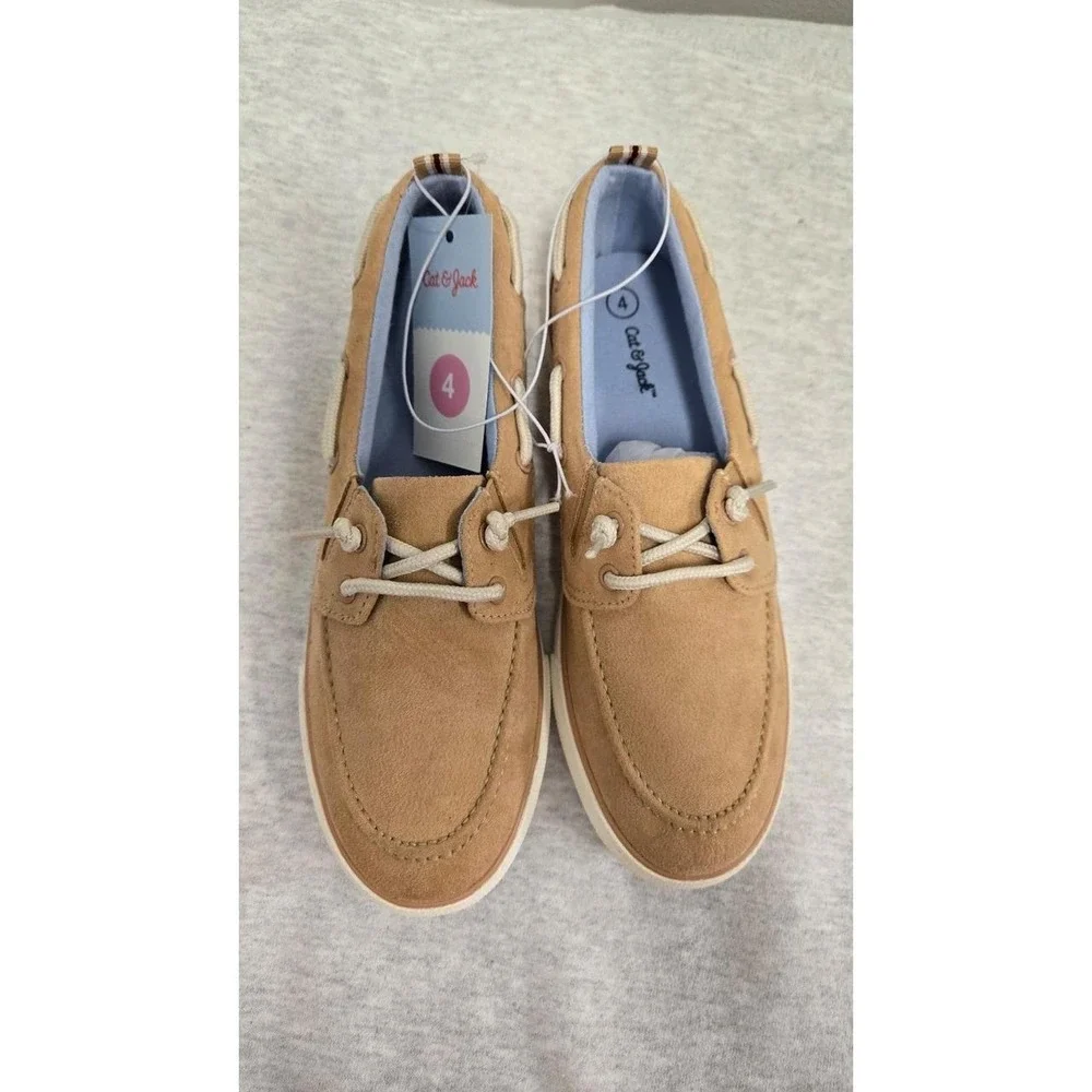 Boys Beige suede boat shoes with white laces. Size: US 4